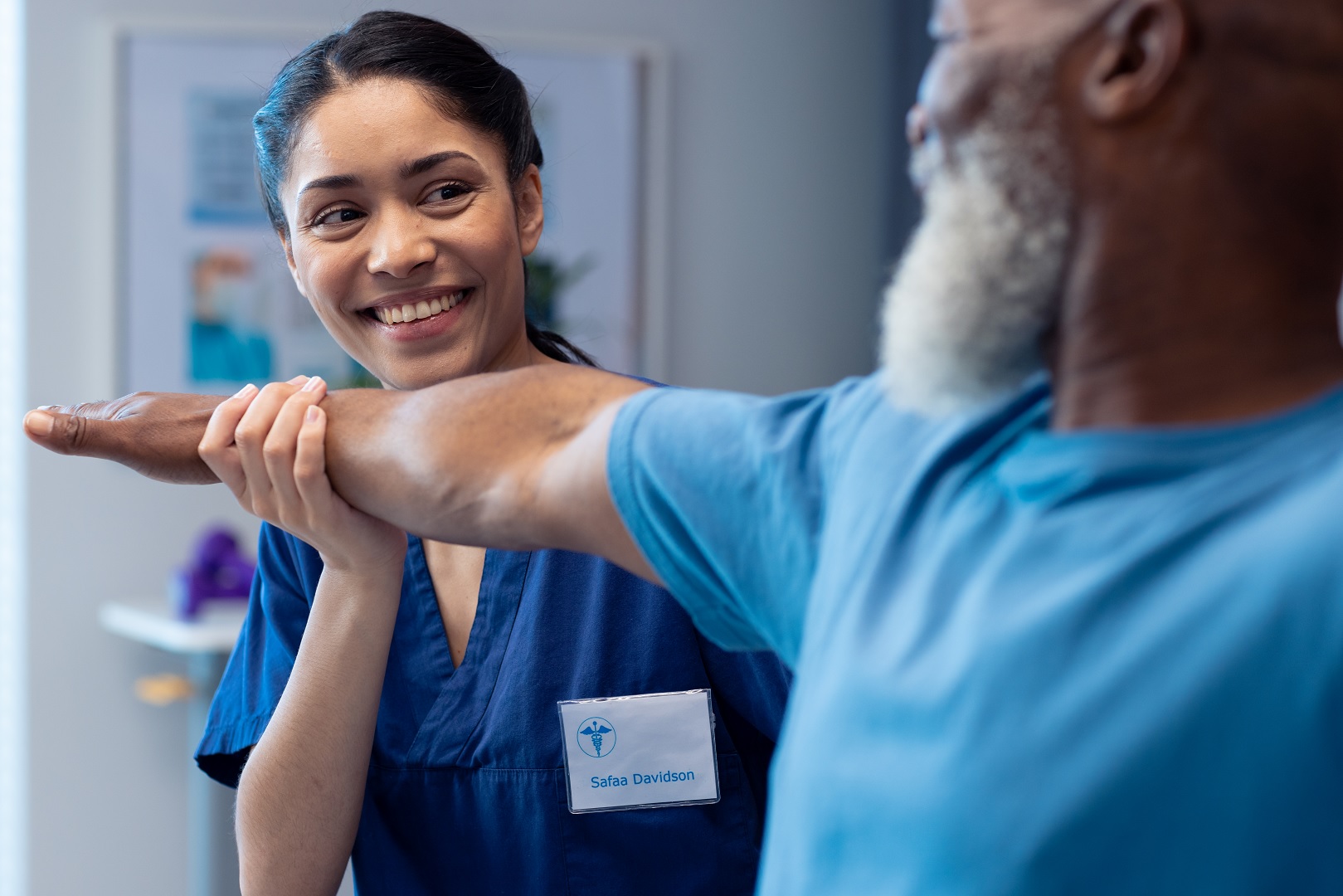 Smiling physical therapist with patient providing patient experience with medical documentation